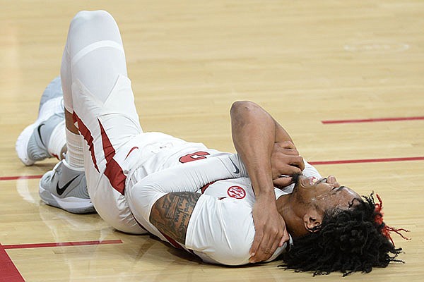 Arkansas guard Desi Sills grabs his shoulder after taking a hard fall during a game against Mississippi State on Tuesday, Feb. 2, 2021, in Fayetteville. 