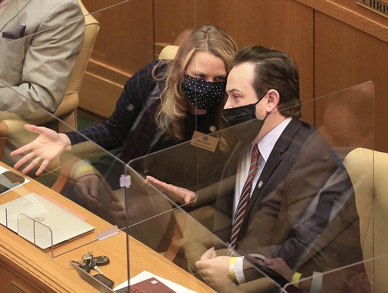 Rep. Megan Godfrey, D-Springdale, left, talks with Rep. Andrew Collins, D-Little Rock, Wednesday Feb. 3, 2021 at the state Capitol in Little Rock. (Arkansas Democrat-Gazette/Staton Breidenthal)

