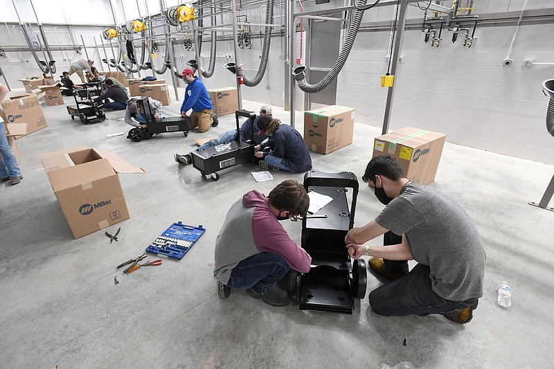 Ryan Cook (right) of Farmington works with fellow student Seth Stubblefield of Bentonville to assemble a welding cart at Northwest Technical Institute in Springdale in this Sept. 30, 2020, file photo.