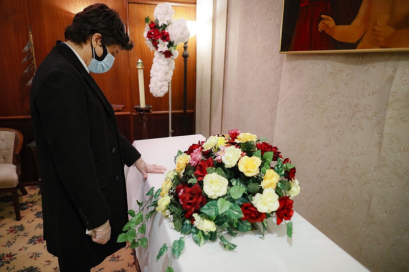 Leonardo Cabana cries over the casket of his father, Hector Cabana, at a funeral home in Brooklyn, N.Y., in this May 11, 2020, file photo. Hector Cabana died of covid-19.