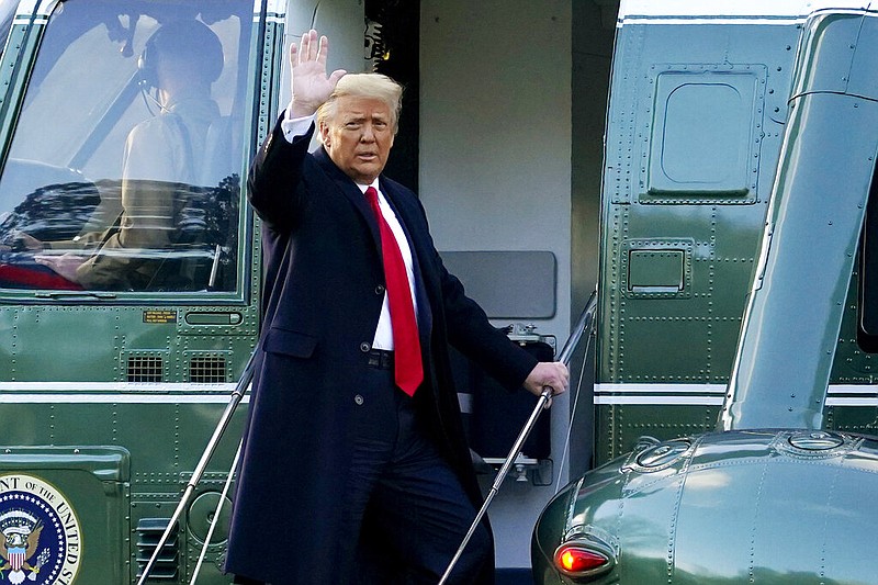President Donald Trump waves as he boards Marine One on the South Lawn of the White House in Washington en route to his Mar-a-Lago resort in Florida on his final day in office Jan. 20, 2021.