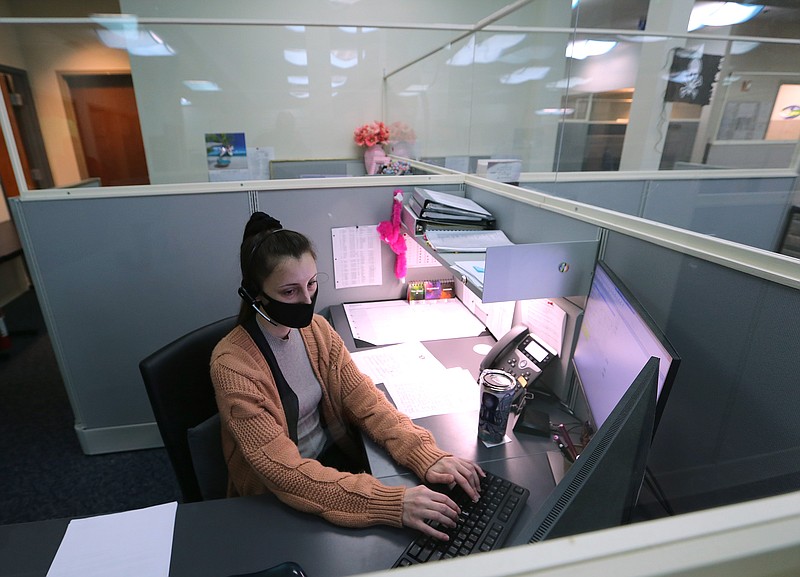 Arkansas child abuse hotline operator Brittany Irby works on abuse reports at her workstation on Jan. 27 at the Arkansas State Police headquarters in Little Rock.