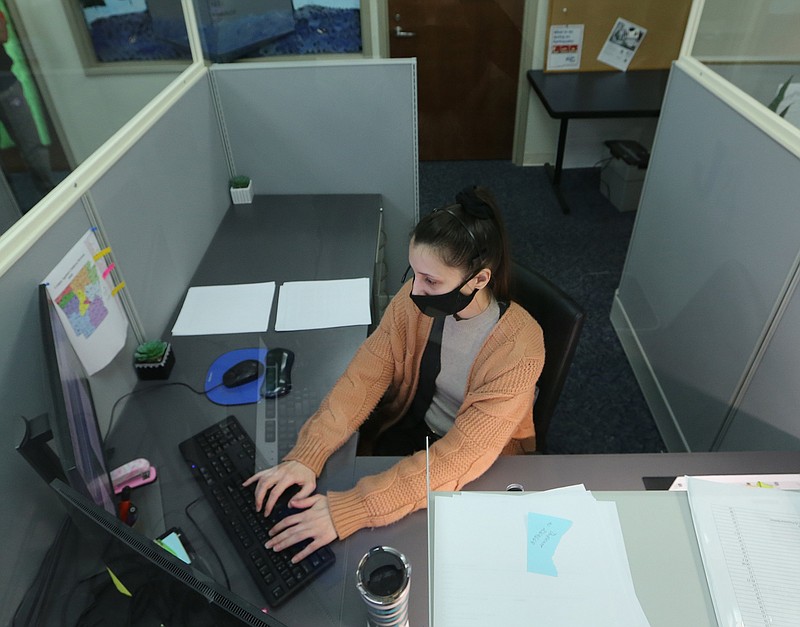 Brittany Irby, a state child abuse hotline operator, works on abuse reports at her workstation Jan. 27 at the Arkansas State Police headquarters in Little Rock.