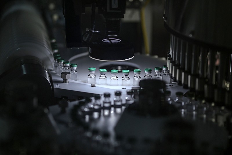 Vials of Covishield, the local name for the covid-19 vaccine developed by AstraZeneca and the University of Oxford, move along a conveyor on the production line at the Serum Institute of India Ltd. Hadaspar plant in Pune, Maharashtra, India, on Jan. 22, 2021. MUST CREDIT: Bloomberg photo by Dhiraj Singh. story.lead_photo.caption