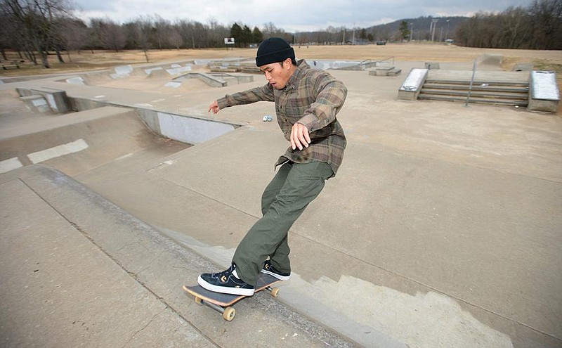 Jedd Ramos of Fayetteville skates Thursday at Grinders Skate Park in Walker Park in Fayetteville. Fayetteville’s City Council approved Tuesday an $88,000 project to install timed, night-sky-friendly LED lighting at the skate park, which was constructed in 2003. Go to nwaonline.com/210207Daily/for today’s photo gallery. (NWA Democrat-Gazette/Andy Shupe)