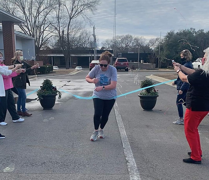 Anna Sanders Warriner crosses the finish line and completes her 105th mile to raise money for The Hub. (Contributed)