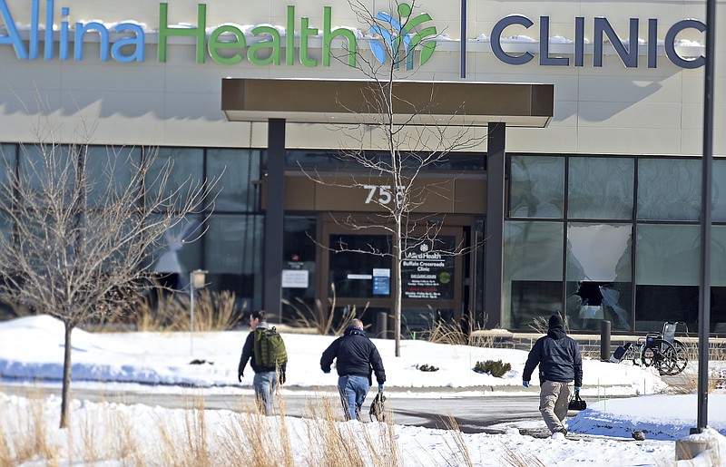 Law enforcement personnel walk toward the Allina Health clinic, Tuesday, Feb. 9, 2021, in Buffalo, Minn. Authorities say multiple people were shot at the Minnesota health clinic on Tuesday and someone was taken into custody afterward. (David Joles/Star Tribune via AP) story.lead_photo.caption