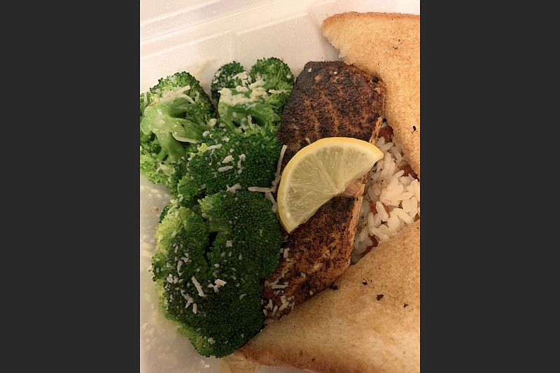 A nice chunk of lightly blackened salmon, fresh steamed broccoli, flavored rice and Texas toast made for an enjoyable dinner from Big Whiskey's, just on the edge of Little Rock's River Market. (Arkansas Democrat-Gazette/Eric E. Harrison)