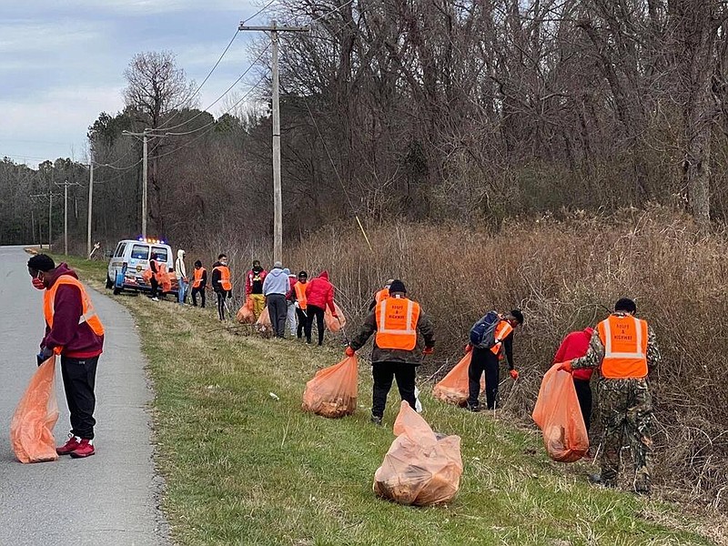 Members of the Gamma Sigma Chapter and Pine Bluff Alumni Chapter of Kappa Alpha Psi Fraternity Inc. along with members of Kappa League, Kappa’s national guide right national service program, collect trash along McFadden Road as part of the ‘Kappa Kleans.’ 
(Special to The Commercial)