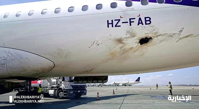 Damage is visible Wednesday on a plane after an attack by Yemen’s Houthi rebels at an airport near Abha, Saudi Arabia.
(AP)