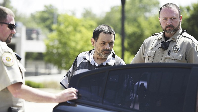 Mauricio Torres is escorted out of the Benton County Courthouse Annex in Bentonville in this June 2019 file photo.