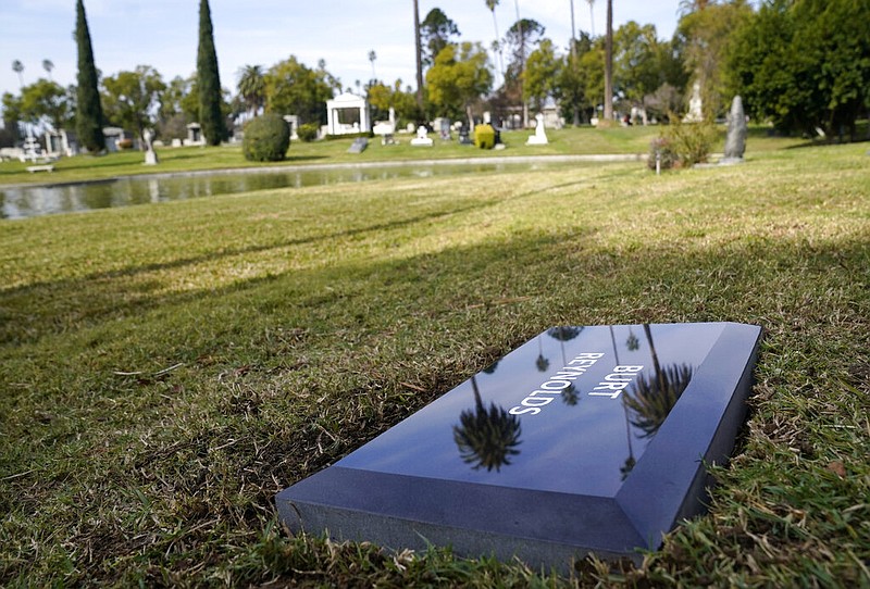 A temporary headstone for the late actor Burt Reynolds is pictured in the Garden of Legends section of Hollywood Forever cemetery in Los Angeles on Thursday, Feb. 11, 2021. Reynolds' cremated remains were moved from Florida to Hollywood Forever, where a small ceremony was held Thursday. A permanent gravesite will be put up for Reynolds in a few months.