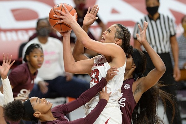 Arkansas guard Chelsea Dungee (center) takes a shot in the lane Thursday, Feb. 11, 2021, as she collides with Mississippi State guard Jamya Mingo-Young (left) during the first half of play in Bud Walton Arena. Visit nwaonline.com/210212Daily/ for the photo gallery. 