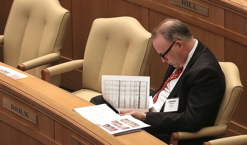 Then-Rep.-elect Marsh Davis, R-Cherokee Village, looks over the revenue forecast in the House chamber at Little Rock during orientation for new House members in this Dec. 5, 2018, file photo.