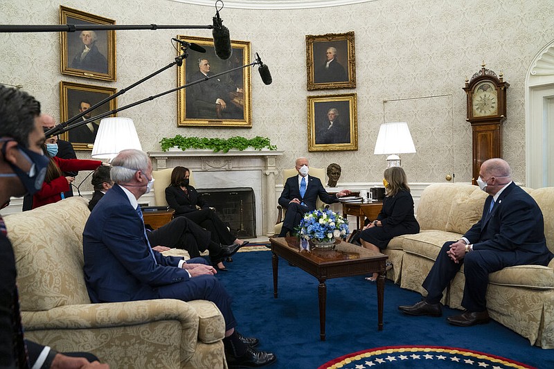 Gov. Asa Hutchinson (seated in couch, foreground left), R-Ark., joins President Joe Biden in the Oval Office of the White House on Friday, Feb. 12, 2021. Hutchinson was part of a bipartisan group of mayors and governors discussing a coronavirus relief package. From left are Mayor Francis Suarez, D-Miami; Gov. Andrew Cuomo (to Hutchinson's left), D-N.Y.; Hutchinson; Vice President Kamala Harris; Biden; Gov. Michelle Lujan Grisham, D-N.M.; and Gov. Larry Hogan, R-Md.