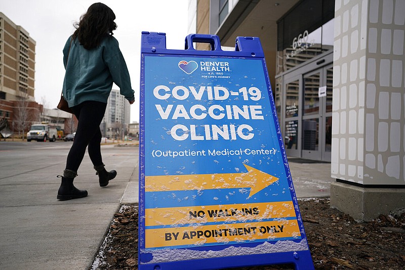 A woman heads in for a covid-19 vaccination during a mass vaccination of 1,000 employees of Denver Public Schools at Denver Health on Saturday, Feb. 13, 2021. The mass vaccination of employees including teachers, administrators, custodial workers and bus drivers was the largest to date for employees of the Colorado school system, which plans even more of the events to protect its workers against the coronavirus in the weeks ahead.
