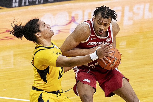 Arkansas' Moses Moody, right, slams into Missouri's Dru Smith, left, as he drives during the first half of an NCAA college basketball game Saturday, Feb. 13, 2021, in Columbia, Mo. (AP Photo/L.G. Patterson)


