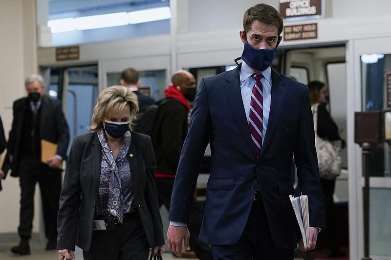 Republican Sens. Cindy Hyde-Smith of Mississippi and Tom Cotton of Arkansas walk Friday to hear defense arguments in the fourth day of the second impeachment trial of former President Donald Trump.
(AP/Susan Walsh)