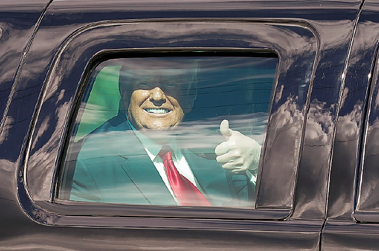 President Donald Trump gestures to supporters en route to his Mar-a-Lago Florida Resort on Wednesday, Jan. 20, 2021, in West Palm Beach, Fla.