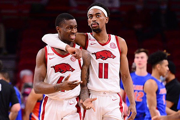 Arkansas guards Davonte Davis (4) and Jalen Tate (11) are shown during a game against Florida on Tuesday, Feb. 16, 2021, in Fayetteville. 