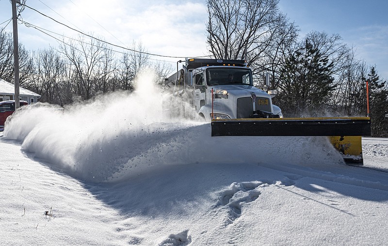 A snow plow clears Theodore Drive in Bella Vista early Tuesday February 16, 20201 morning. Check out nwaonline.com/210217Daily/ for todayÕs photo gallery.
(NWA Democrat-Gazette/Spencer Tirey)