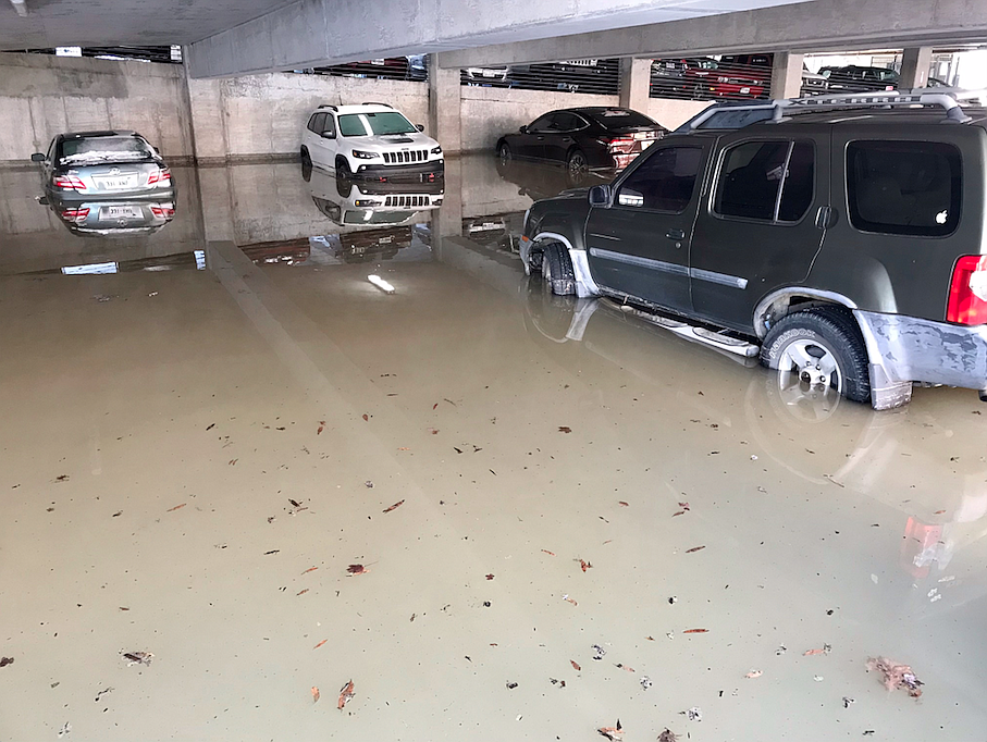 Cars are submerged in water in the Mann on Main parking deck after a water main broke on the 100 block of West 4th Street in downtown Little Rock. The road is closed between Main and Louisiana streets. 