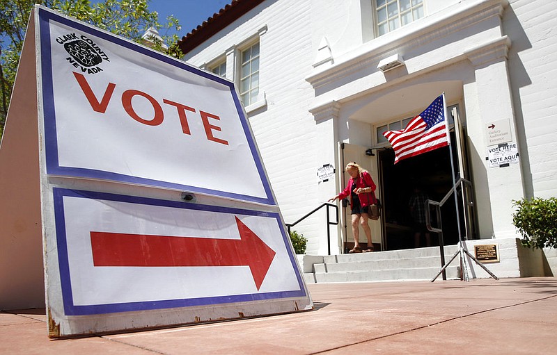 A woman walks out of a polling place after voting in the Nevada primary election in Las Vegas in this June 14, 2016, file photo.