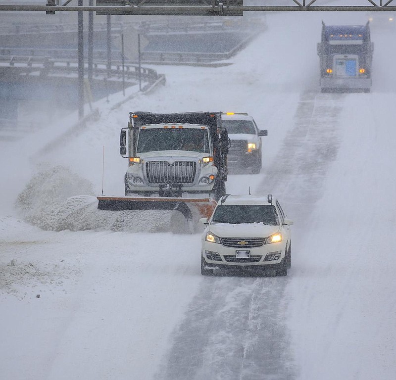 A state Department of Transportation snowplow clears the way Wednesday on westbound Interstate 30 in Little Rock as a second snowstorm socks the state. “We are plowing like crazy,” agency spokesman Dave Parker said, noting the many accidents occurring. More photos at arkansasonline/218snow/.
(Arkansas Democrat-Gazette/Staton Breidenthal)