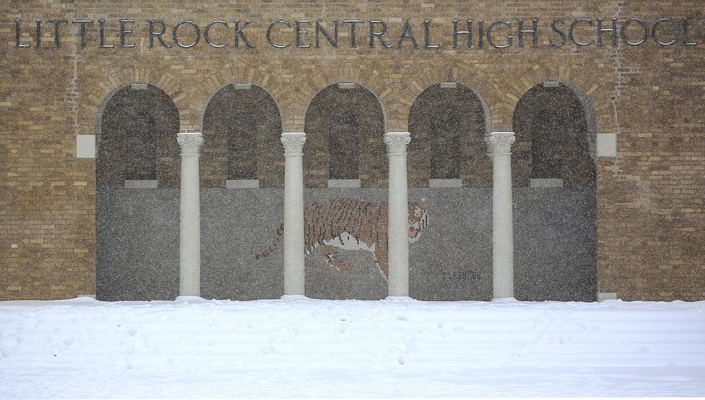 Falling snow layers over the steps at Little Rock Central High School on Wednesday as a second round of heavy snow hits the state. The snow was forecast to end today, but cold weather will continue for another couple of days.
(Arkansas Democrat-Gazette/Staton Breidenthal)