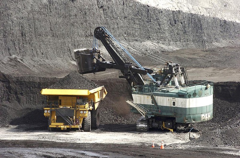 A mechanized shovel loads a truck with coal at the Spring Creek coal mine near Decker, Mont., in this April 2013 file photo. As the Biden administration tackles climate change, coal miners and oil workers fear for their jobs.
(AP)