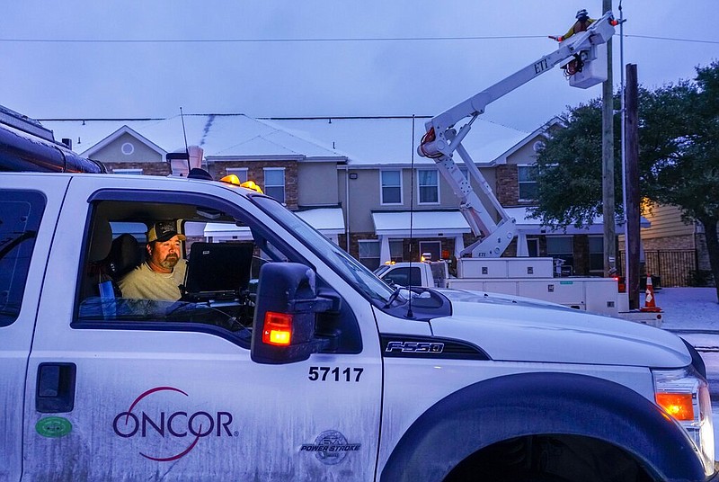 An Oncor crew works on along Elsie Faye Higgins Street as power outages continue across the state after a second winter storm brought more snow and continued freezing temperatures to North Texas on Wednesday, Feb. 17, 2021, in Dallas. 