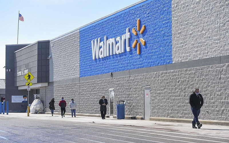 Shoppers come and go Thursday at the Walmart Supercenter in Bentonville. The Bentonville-based retailer released its quarterly earnings report Thursday, posting a net loss of $2.09 billion.
(NWA Democrat-Gazette/Charlie Kaijo)