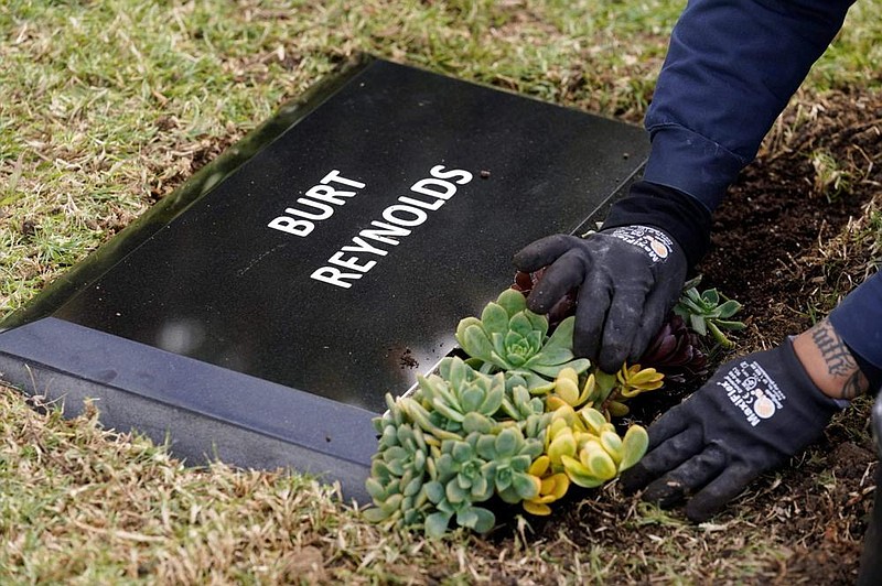 Flowers are placed in front of a temporary headstone for the late actor Burt Reynolds in the Garden of Legends section of Hollywood Forever cemetery on Feb. 11 in Los Angeles. Reynolds' cremated remains were moved from Florida to Hollywood Forever. A permanent gravesite will be put up for Reynolds in a few months. 
(AP Photo/Chris Pizzello)
