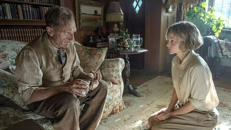 Amateur archaeologist Basil Brown (Ralph Fiennes) gives counsel to widow Edith Pretty (Carey Mulligan), who suspects that the mounds on her estate might be harboring something in the Netflix film “The Dig.”
