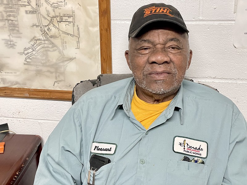 Bud Miles sits in the Department of Public Works office, proudly wearing his “Pleasant” name badge. (Marvin Richards/News-Times)