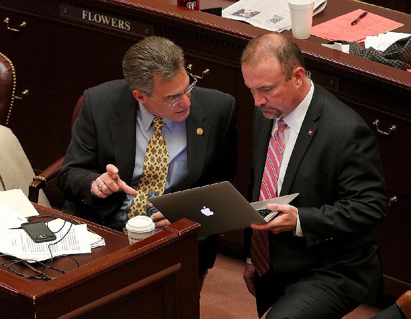 State Rep. Les Eaves (right), R-Searcy, listens to then-Rep. Charlie Collins on the floor of the state House in the Capitol in this March 2017 file photo.