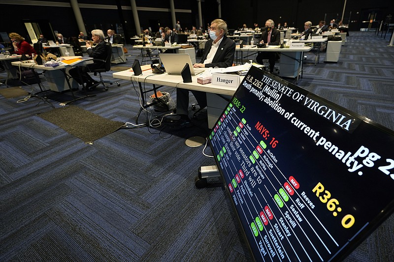 Virginia State Sen. Emmett Hanger, R-Augusta, front, looks at the vote tally board during a vote on a death penalty abolition bill at the Senate session at the Science Museum of Virginia in Richmond, Va., Monday, Feb. 22, 2021. The Senate passed the bill 22-16. (AP Photo/Steve Helber)