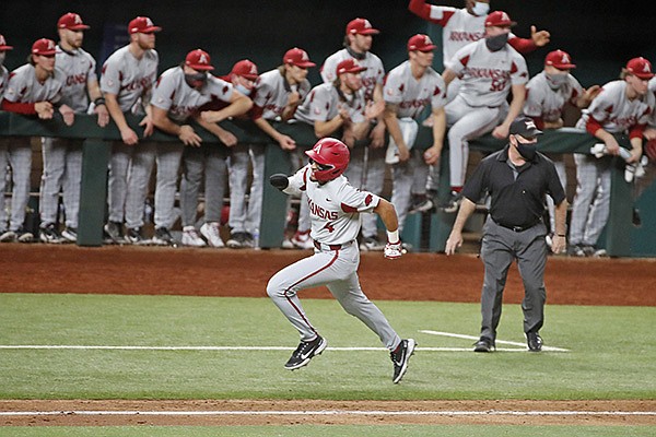 Arkansas shortstop Jalen Battles runs toward home plate to score the tying run during the eighth inning of a game against TCU on Monday, Feb. 22, 2021, in Arlington, Texas. The Razorbacks defeated the Horned Frogs 4-1.