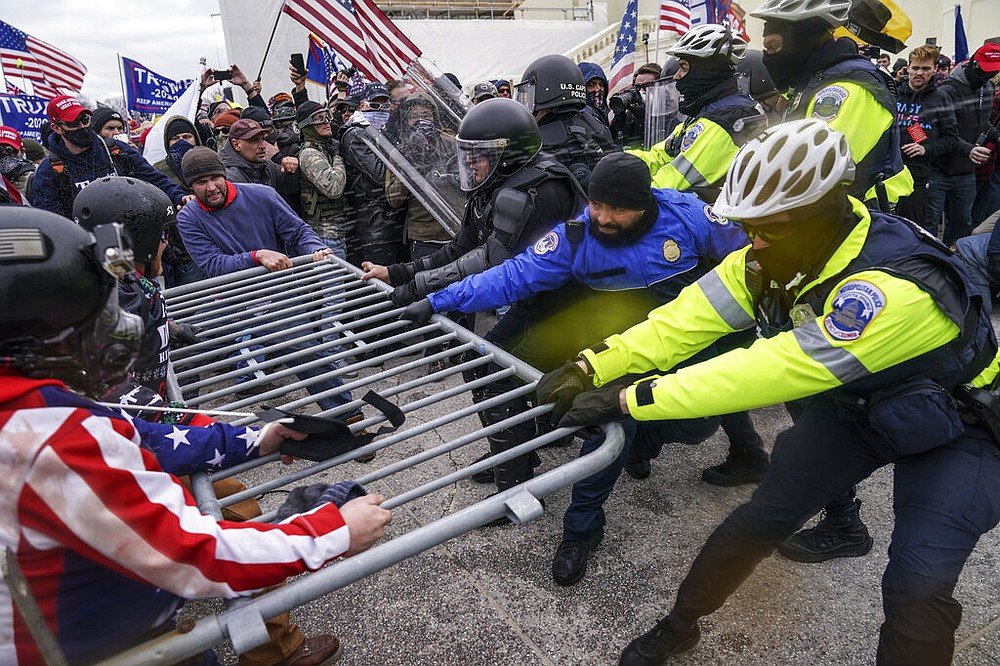 FILE - In this Jan. 6, 2021, file photo rioters try to break through a police barrier at the Capitol in Washington. Congress is set to hear from former security officials about what went wrong at the U.S. Capitol on Jan. 6.