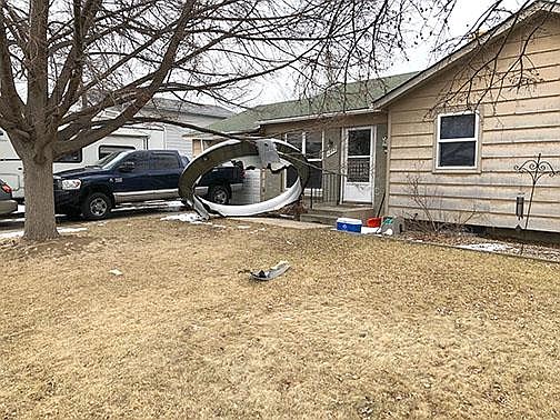 In this photo provided by the Broomfield Police Department on Twitter, debris is scattered in the front yard of a house at near 13th and Elmwood, Saturday, Feb. 20, 2021, in Broomfield, Colo. A commercial airliner dropped debris in Colorado neighborhoods during an emergency landing Saturday. The Broomfield Police Department said on Twitter that the plane landed safely at Denver International Airport and that no injuries had been reported from the incident.  (Broomfield Police Department via AP)