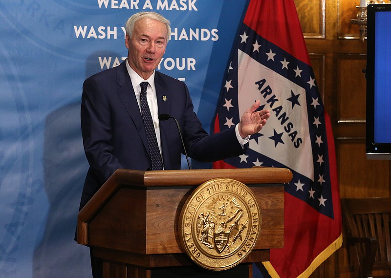 Gov. Asa Hutchinson answers a question during a press conference announcing that the state’s current mask mandate will become a guideline on March 31 if certain public health goals are met on Friday, Feb. 26, at the state Capitol in Little Rock. (Arkansas Democrat-Gazette/Thomas Metthe)