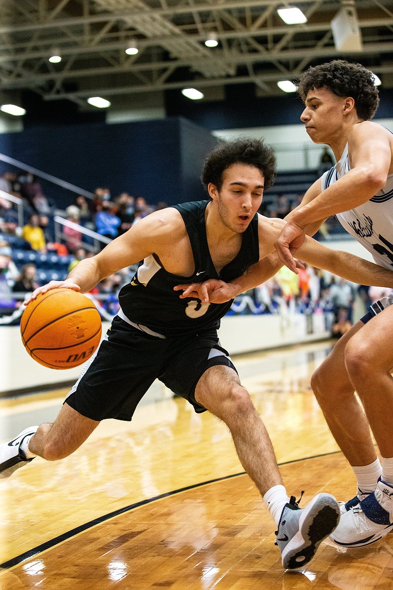 Thane Spencer (0) of Bentonville drives to the basket with Jacob Mcghee (34) of Bentonville West blocking thw way at Wolverine Arena, Centerton, Arkansas on Friday, February 26. 2021. / Special to NWA Democrat-Gazette/ David Beach.