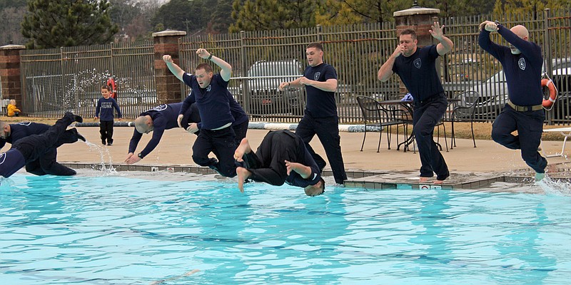 Members of the Hot Springs Police Department’s SWAT team jump into a pool at Hot Springs Health & Fitness on Saturday morning during the 2021 Hot Springs Polar Plunge. - Photo by Tanner Newton of The Sentinel-Record