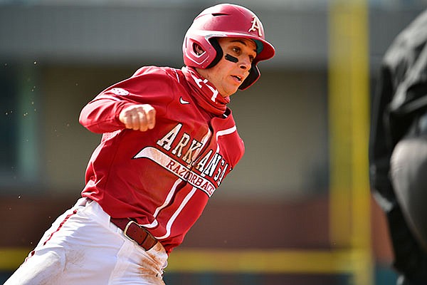 Arkansas' Robert Moore runs toward home plate during a game against Southeast Missouri State on Saturday, Feb. 27, 2021, in Fayetteville. Arkansas' Robert Moore runs toward home plate during a game against Southeast Missouri State on Saturday, Feb. 27, 2021, in Fayetteville.