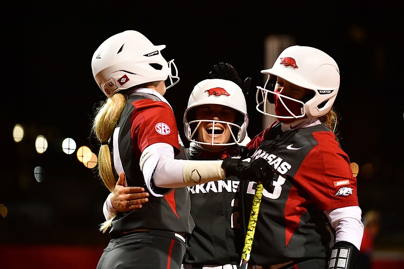 Arkansas' Braxton Burnside (center) is congratulated after hitting a home run during a game against Southeast Missouri State on Saturday, Feb. 27, 2021, in Fayetteville.