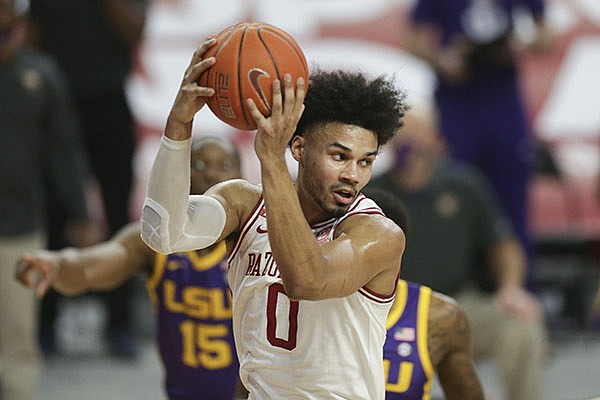 Arkansas forward Justin Smith (0) grabs a rebound during a game against LSU on Saturday, Feb. 27, 2021, in Fayetteville.