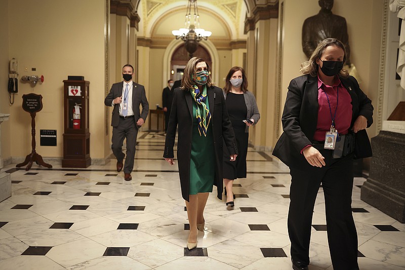 House Speaker Nancy Pelosi (D-Calif.) walks to her office from the House chamber after a vote at the Capitol in Washington, early Saturday morning, Feb. 27, 2021. The $1.9 trillion pandemic aid bill narrowly passed the House, but now must maneuver through a procedural and political thicket in the Senate. (Oliver Contreras/The New York Times)
