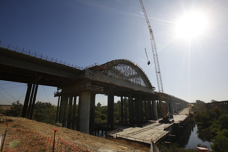 FILE - This Oct. 9, 2019, file photo shows the high speed rail viaduct under construction over the San Joaquin River near Fresno, Calif. A letter from a major contractor blames the state for delays in building California's bullet train, contradicting claims that the line's construction pace is on target and warning the project could miss a key 2022 federal deadline, according to a newspaper report Tuesday, Jan. 12, 2021. (AP Photo/Rich Pedroncelli, File)