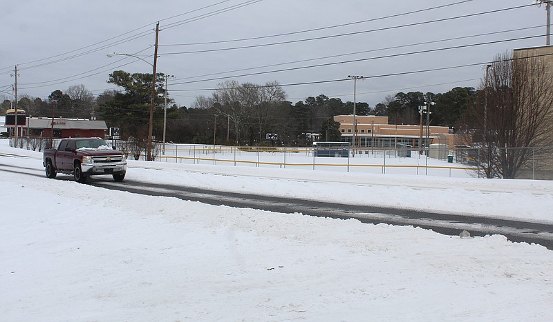 West Avenue’s two lanes were clear of snow and light traffic could be seen slowly traversing it on Feb. 19. City work crews have been catching up and cleaning up behind the snow since the winter weather cleared up last week. (Matt Hutcheson/News-Times)