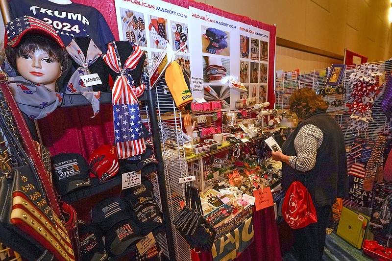 Conservative shirts, hats, ties and other items are displayed for sale at the merchandise show at the Conservative Political Action Conference (CPAC) Saturday, Feb. 27, 2021, in Orlando, Fla. (AP Photo/John Raoux)